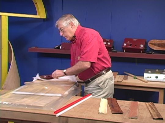 Sliding veneer that has been sprayed with veneer softener into the vacuum bag