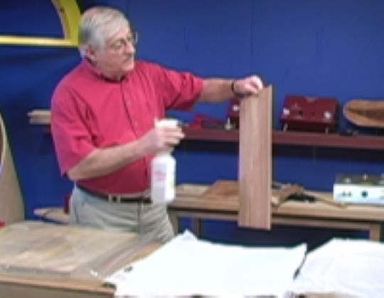 Picture of veneer being sprayed with veneer softening agent to make the veneer more flexable